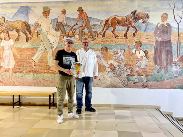 Bruno Schernhammer und Michael Wittig vor dem Fresko von Erwin Lang in der Mittelschule Vorchdorf